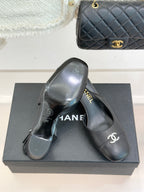 Black leather slingback heels with CHANEL logo on heel and round toe