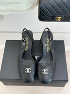 Black leather slingback heels with CHANEL logo at toe and on heel cup