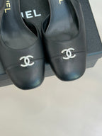 Close-up of black leather slingback toe with CHANEL CC emblem