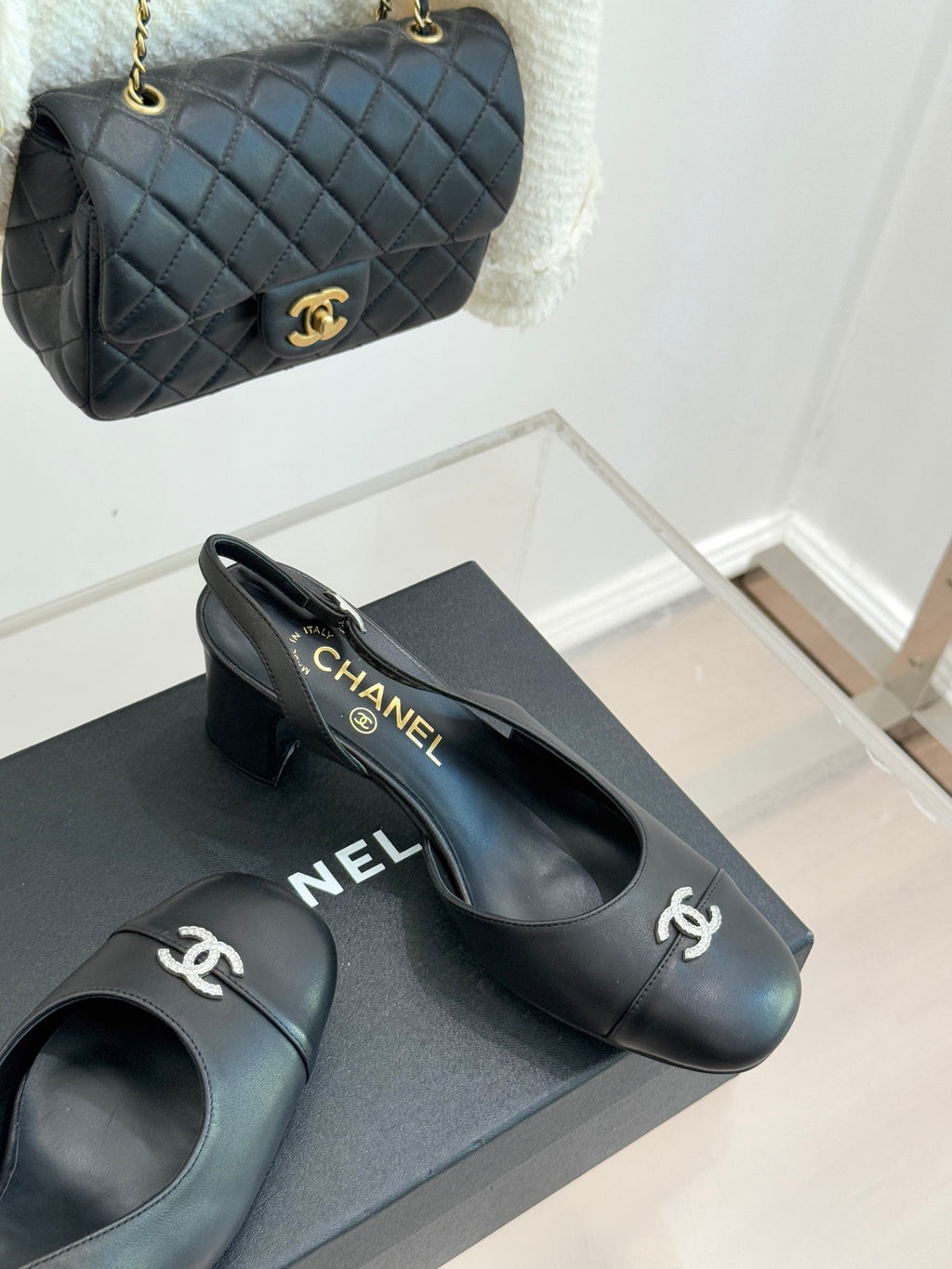 Black leather slingback heels with CHANEL logo on heel and side