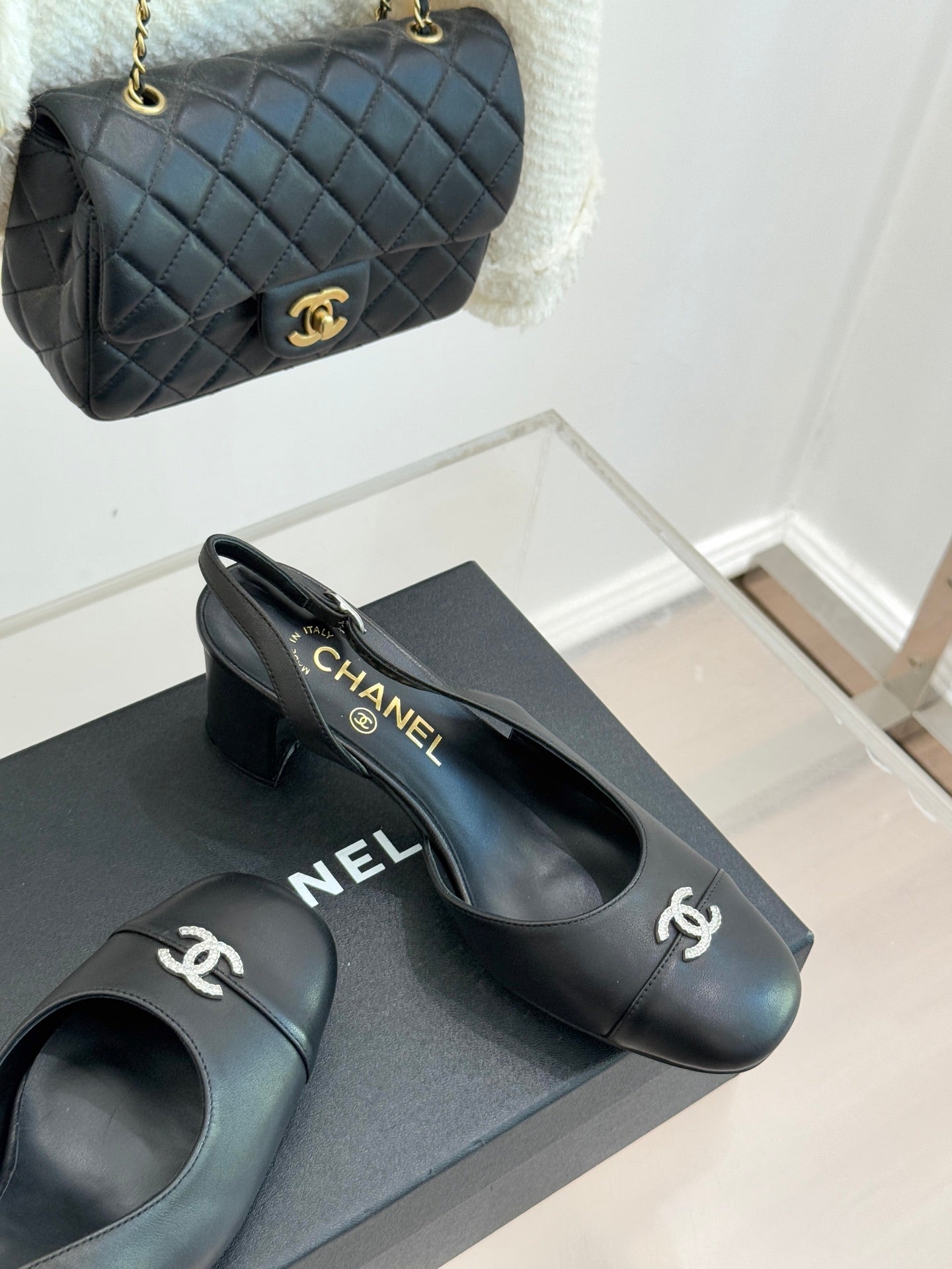 Black leather slingback heels with CHANEL logo on heel and side