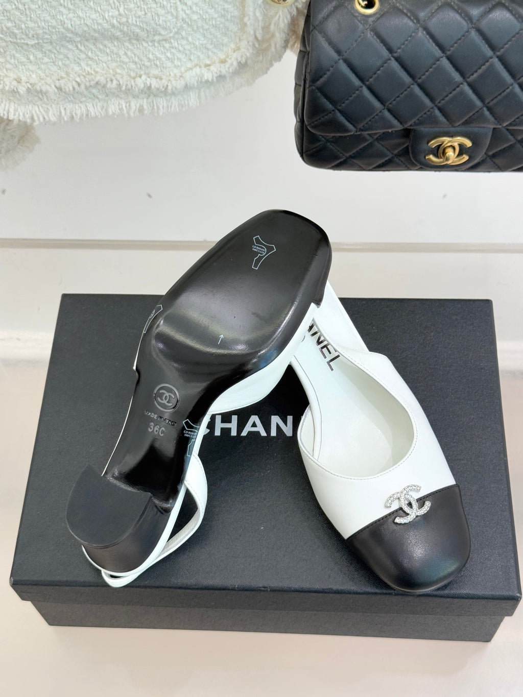 Women's two-tone leather mules on box, white insole with Chanel logo and dark toe caps