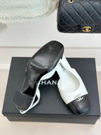 Women's two-tone leather mules on box, white insole with Chanel logo and dark toe caps