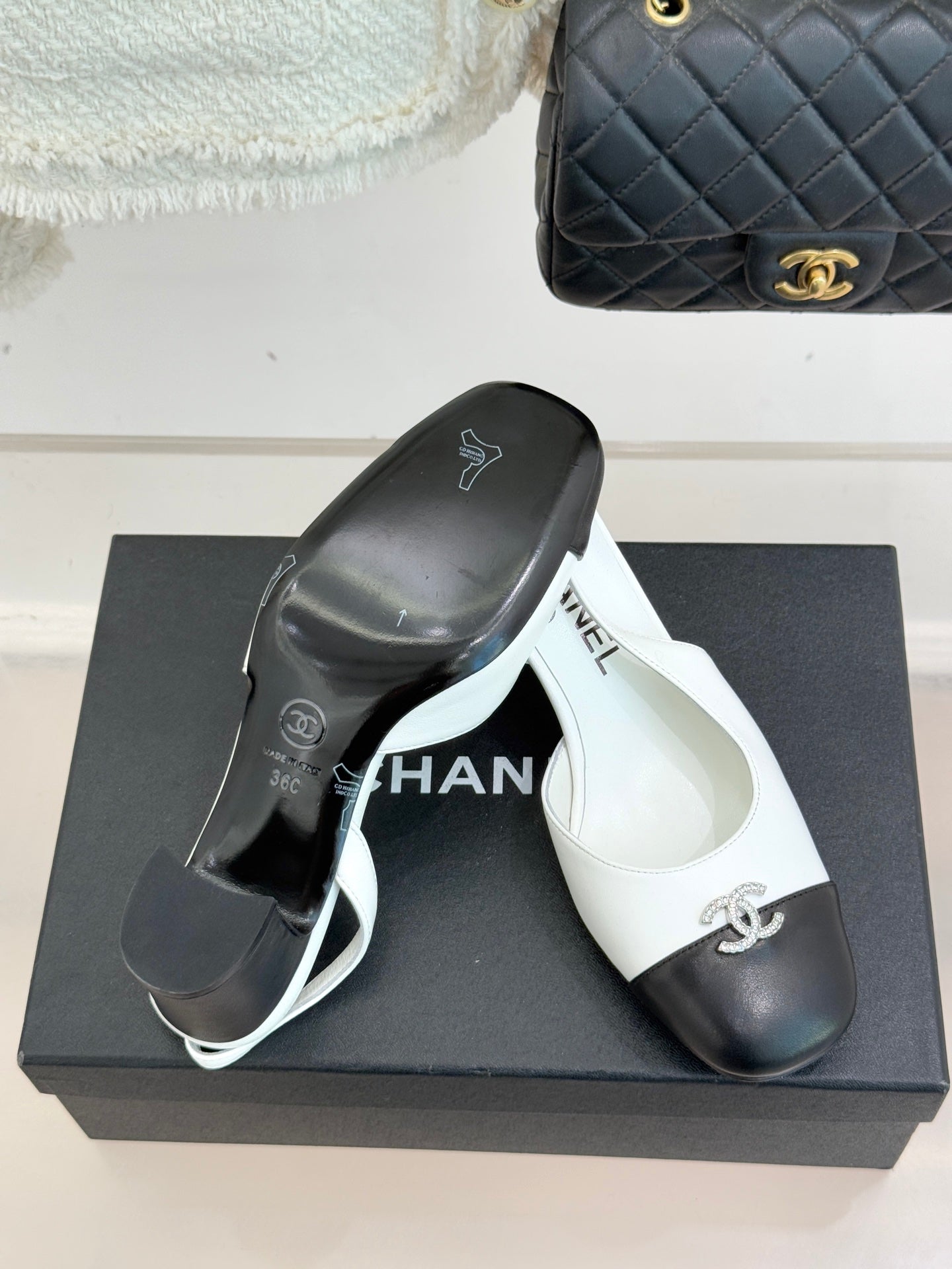 Women's two-tone leather mules on box, white insole with Chanel logo and dark toe caps