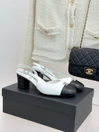Women's two-tone leather mules with bow logo detail, white uppers and dark toe caps