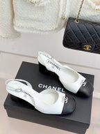 Women's two-tone leather mules with Chanel-style bow, white uppers and dark color block heels