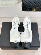 Women's two-tone leather mules with bow ornament, white uppers and dark rounded toe caps