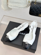 Women's two-tone leather mules on box, white uppers with dark toe caps and bow hardware