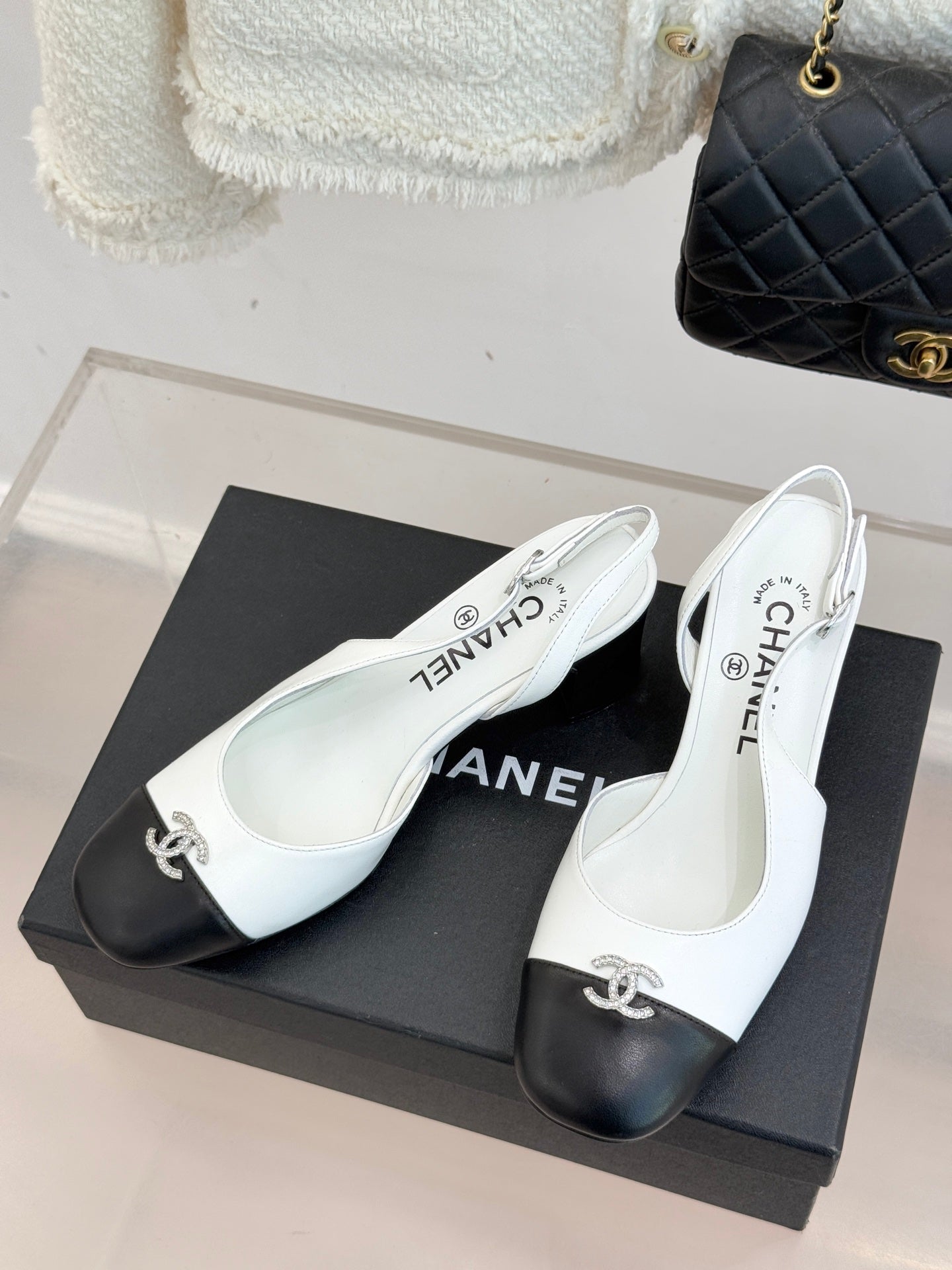 Women's two-tone leather mules on box, white uppers with dark toe caps and bow hardware