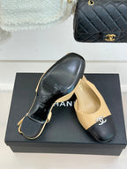 Women's Chanel two-tone slingback heels, beige uppers with black soles and CC emblem.