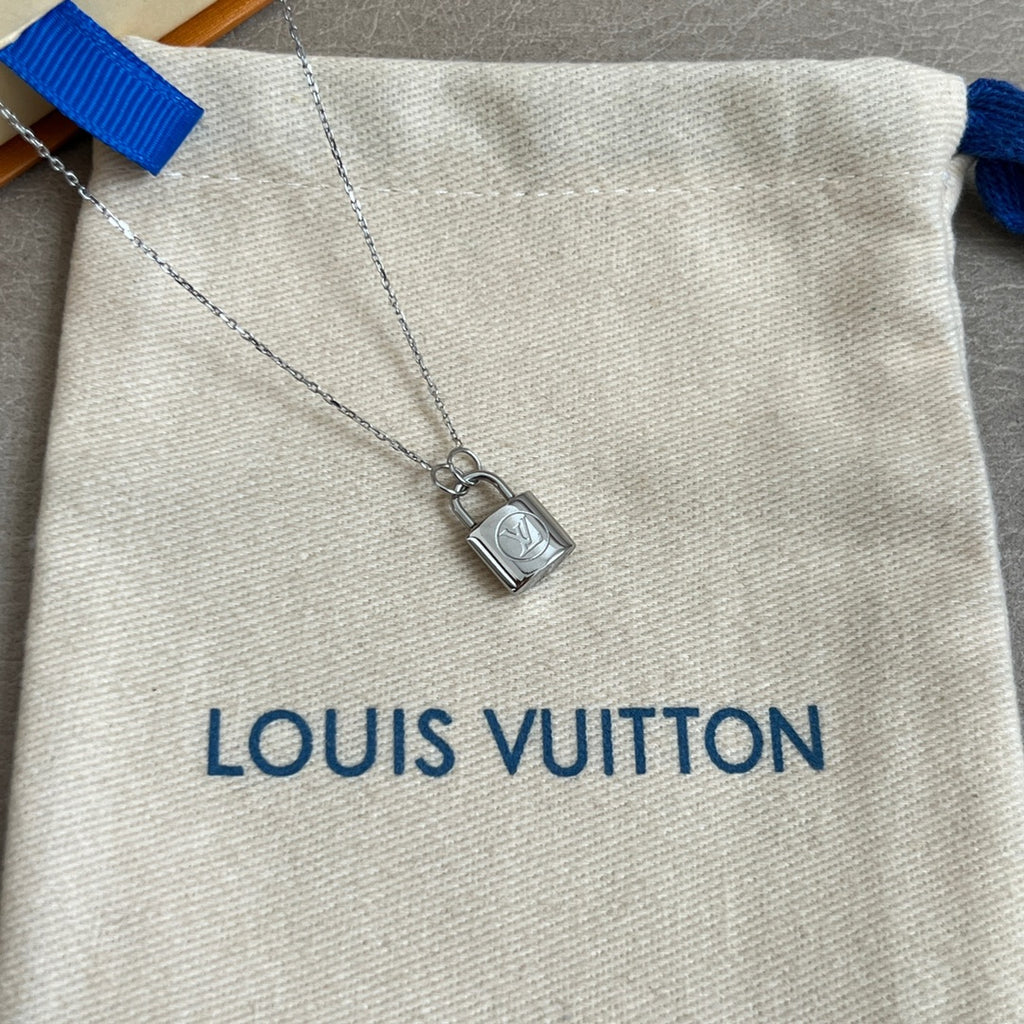 Silver padlock charm necklace pendant detail on white drawstring pouch