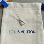 Silver padlock charm necklace pendant detail on white drawstring pouch