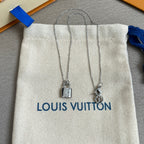 Two silver padlock charm necklaces on white drawstring pouch