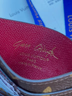 Louis Vuitton monogram leather card holder, magenta interior lining close-up