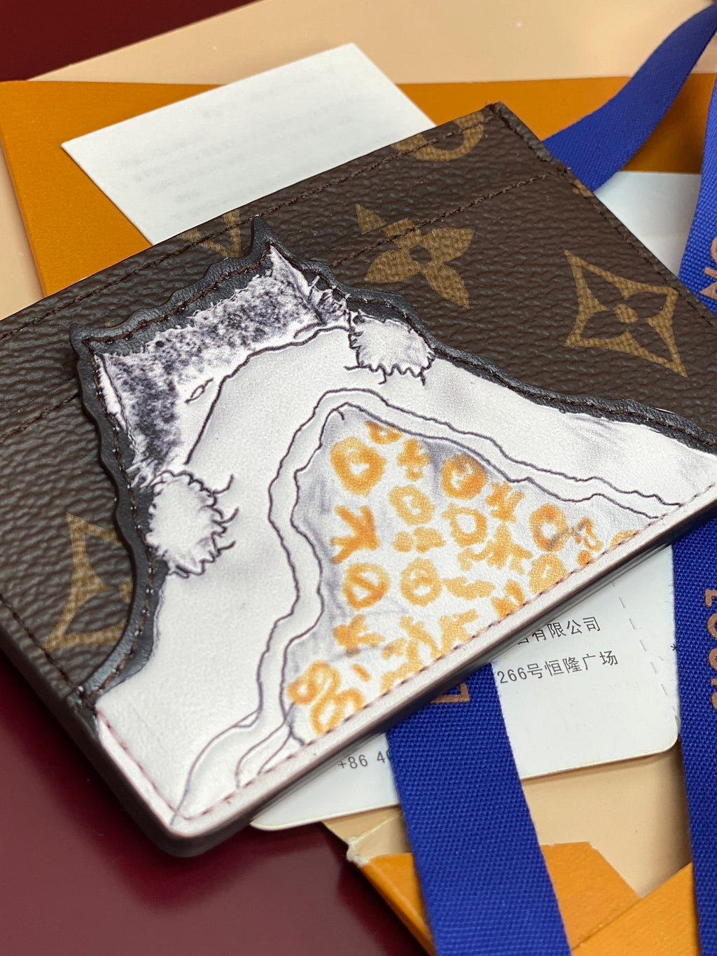 Louis Vuitton small bag interior lining with white map-like print and yellow motifs