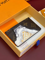 Louis Vuitton monogram card holder with map-style print, dark brown exterior