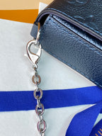 Blue leather bag with silver chain strap and metal clasp