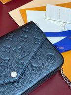 Blue embossed monogram flap bag close-up with snap button
