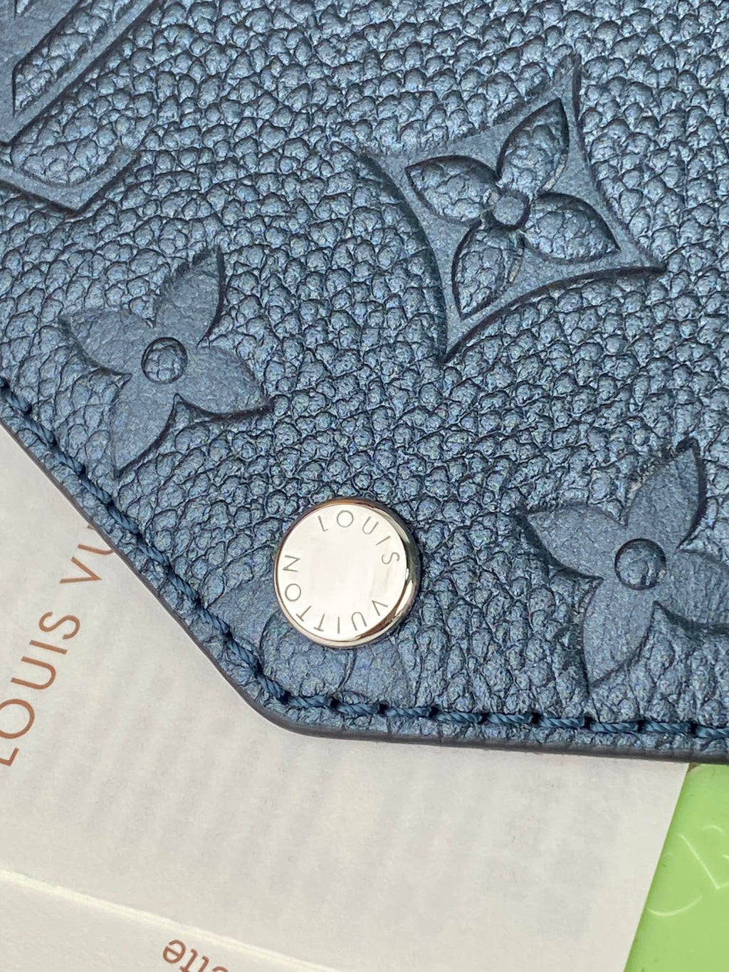 Louis Vuitton bag, blue textured leather with floral pattern and round snap closure