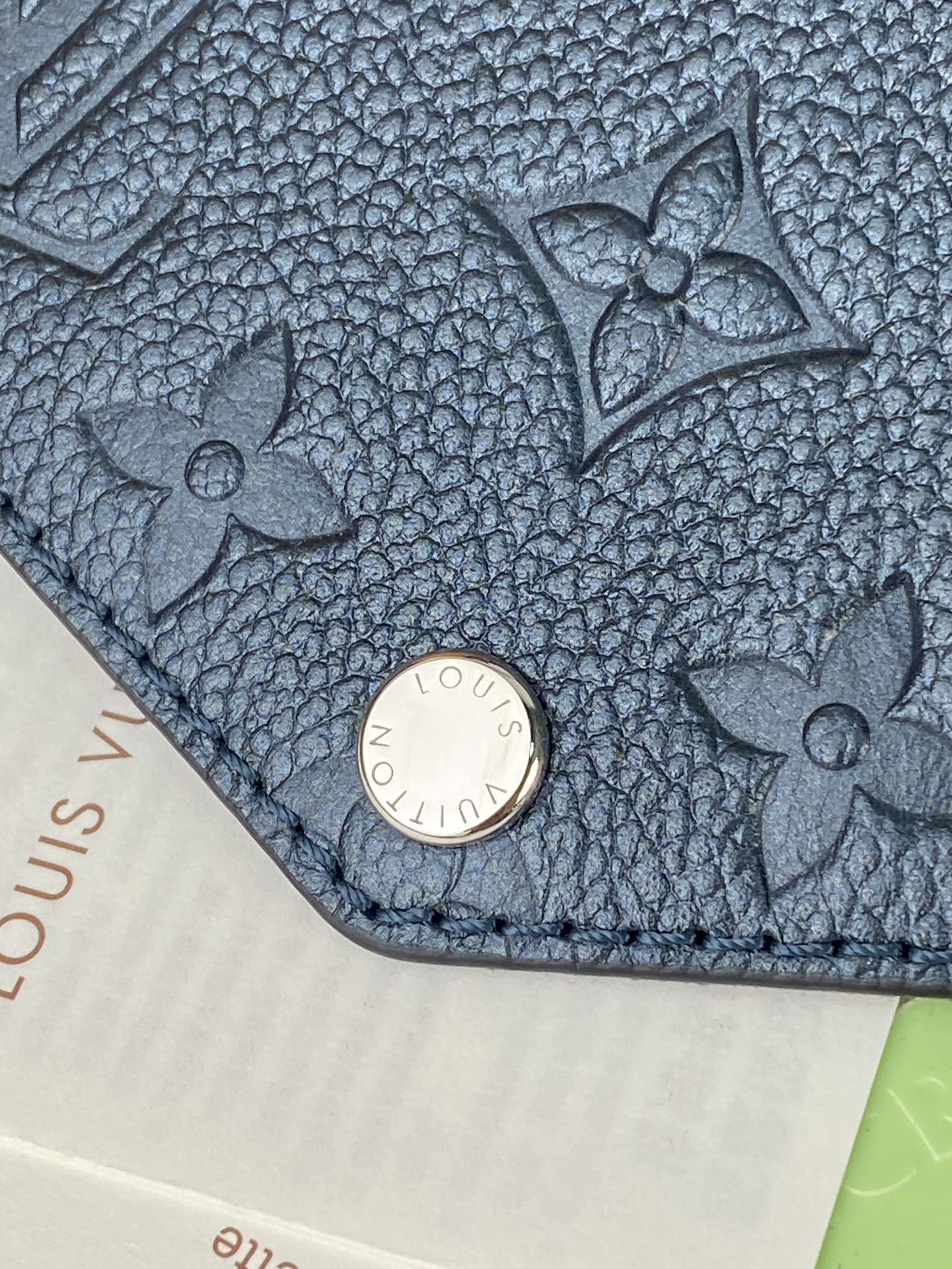 Louis Vuitton bag, blue textured leather with floral pattern and round snap closure