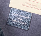 Leather interior label card inside a blue monogram bag