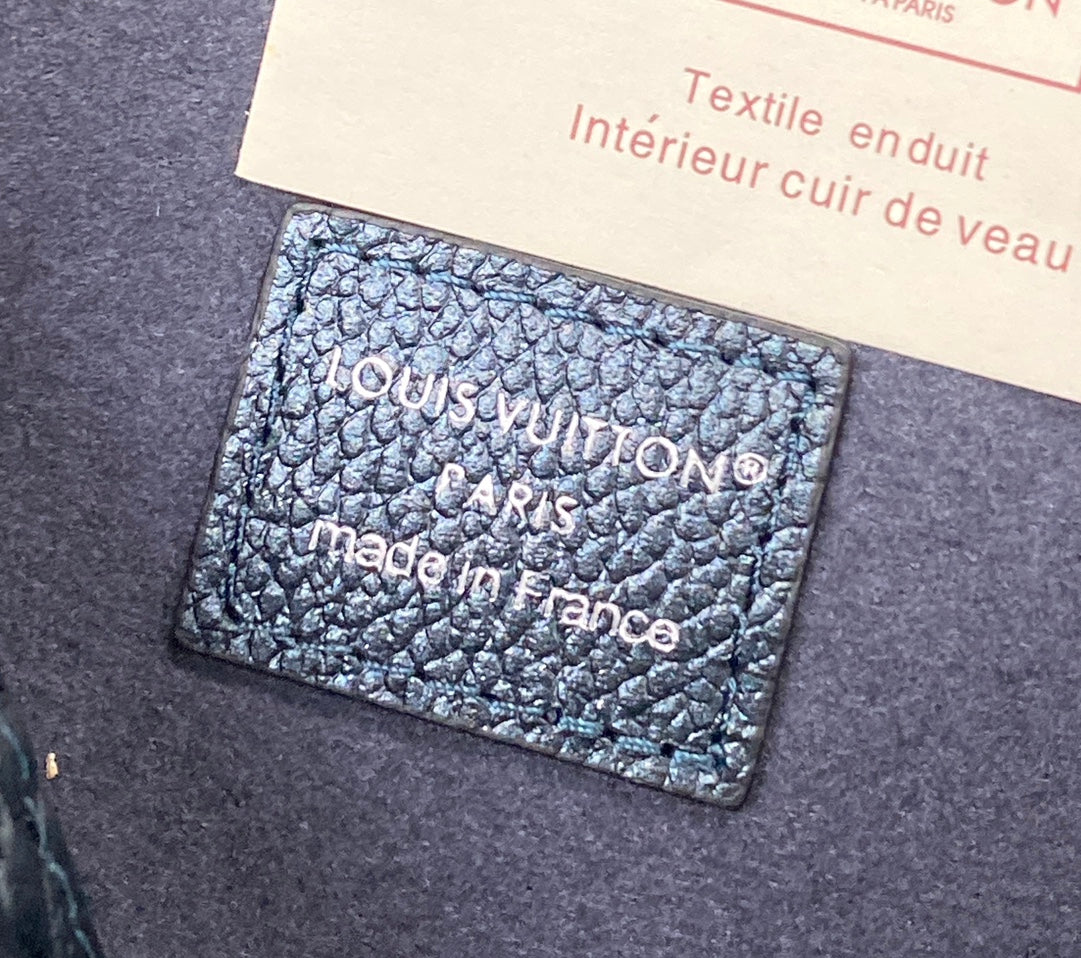 Leather interior label card inside a blue monogram bag