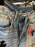 Light-wash denim pants with metal button closure and red cross patch, waistband close