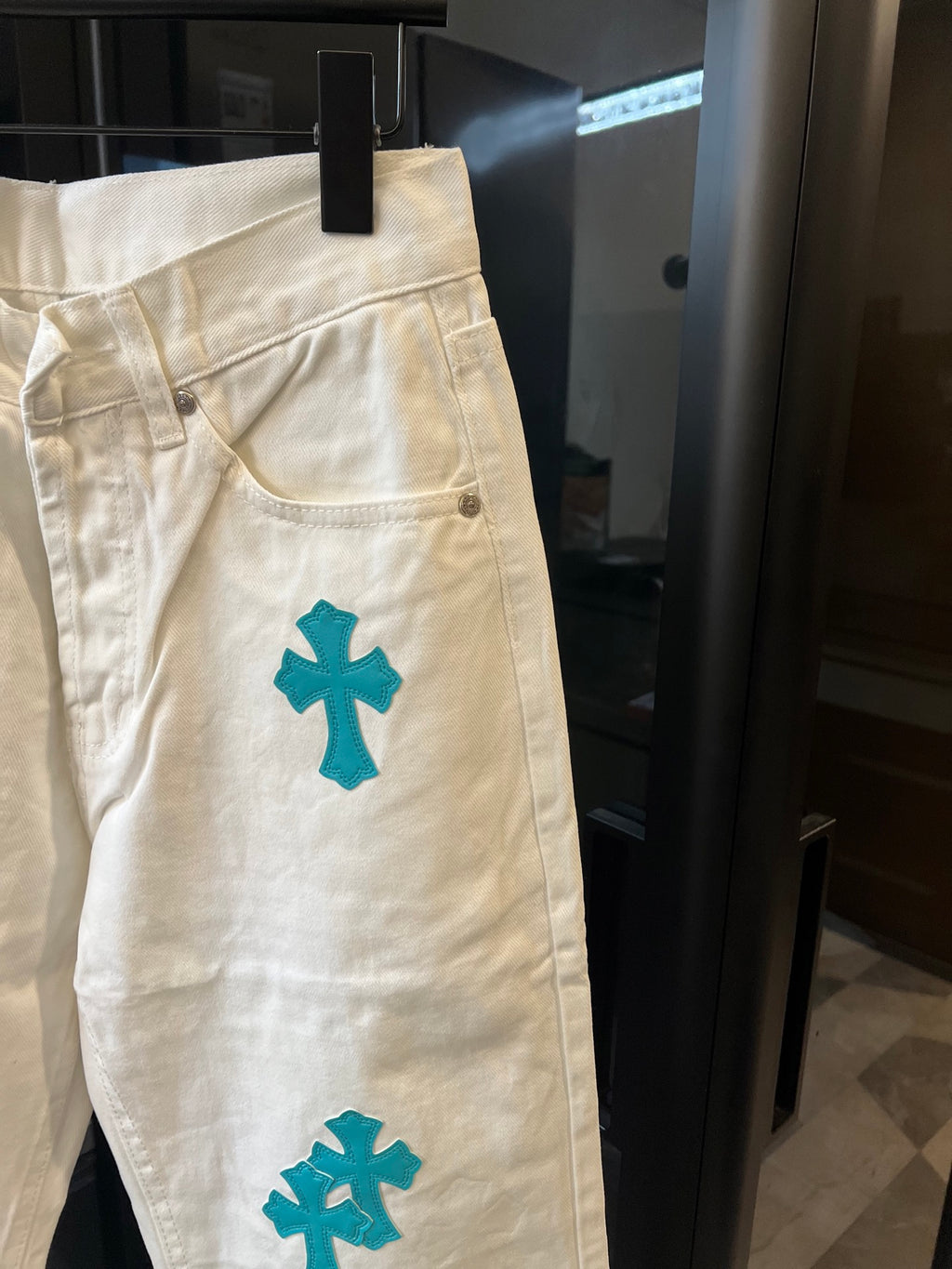 Chrome pants in white with teal cross print, front pocket and curved seam