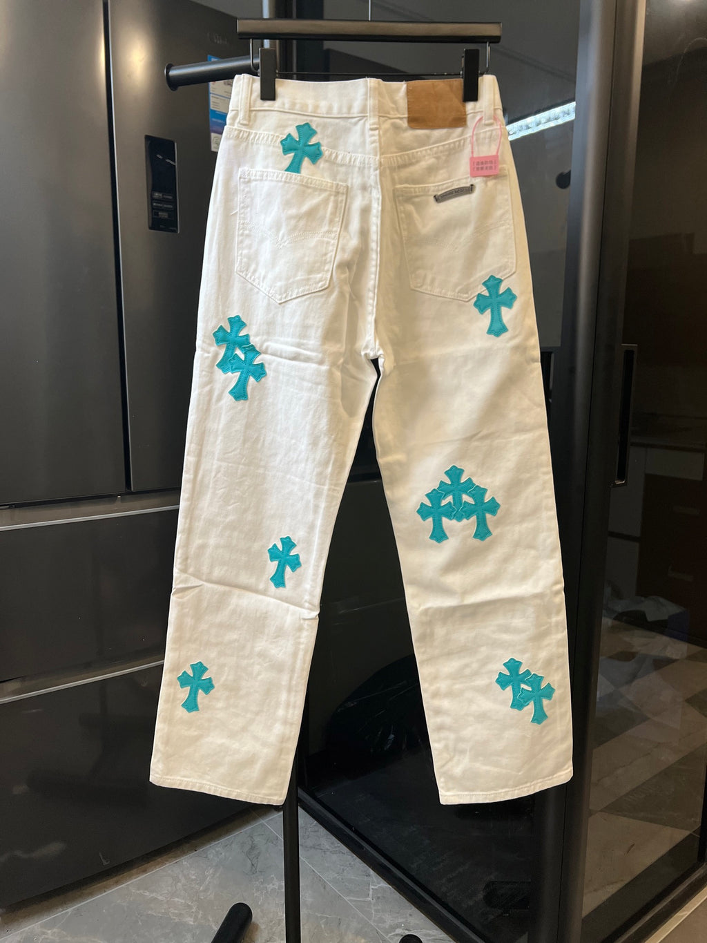 Chrome pants in white with teal cross print, back view with patch pocket