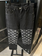 Dark denim pants with white monogram print band at the hems and belt loops