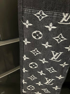 Dark denim fabric with white monogram pattern at the lower leg