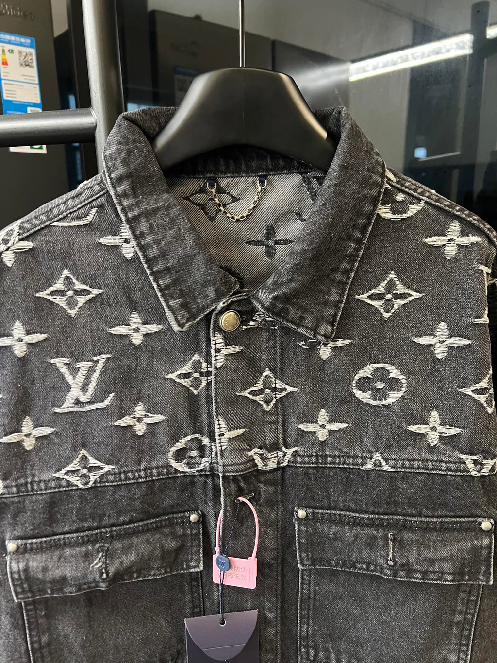 Monogram denim jacket front yoke, button placket and chest pockets, dark gray with cream motifs