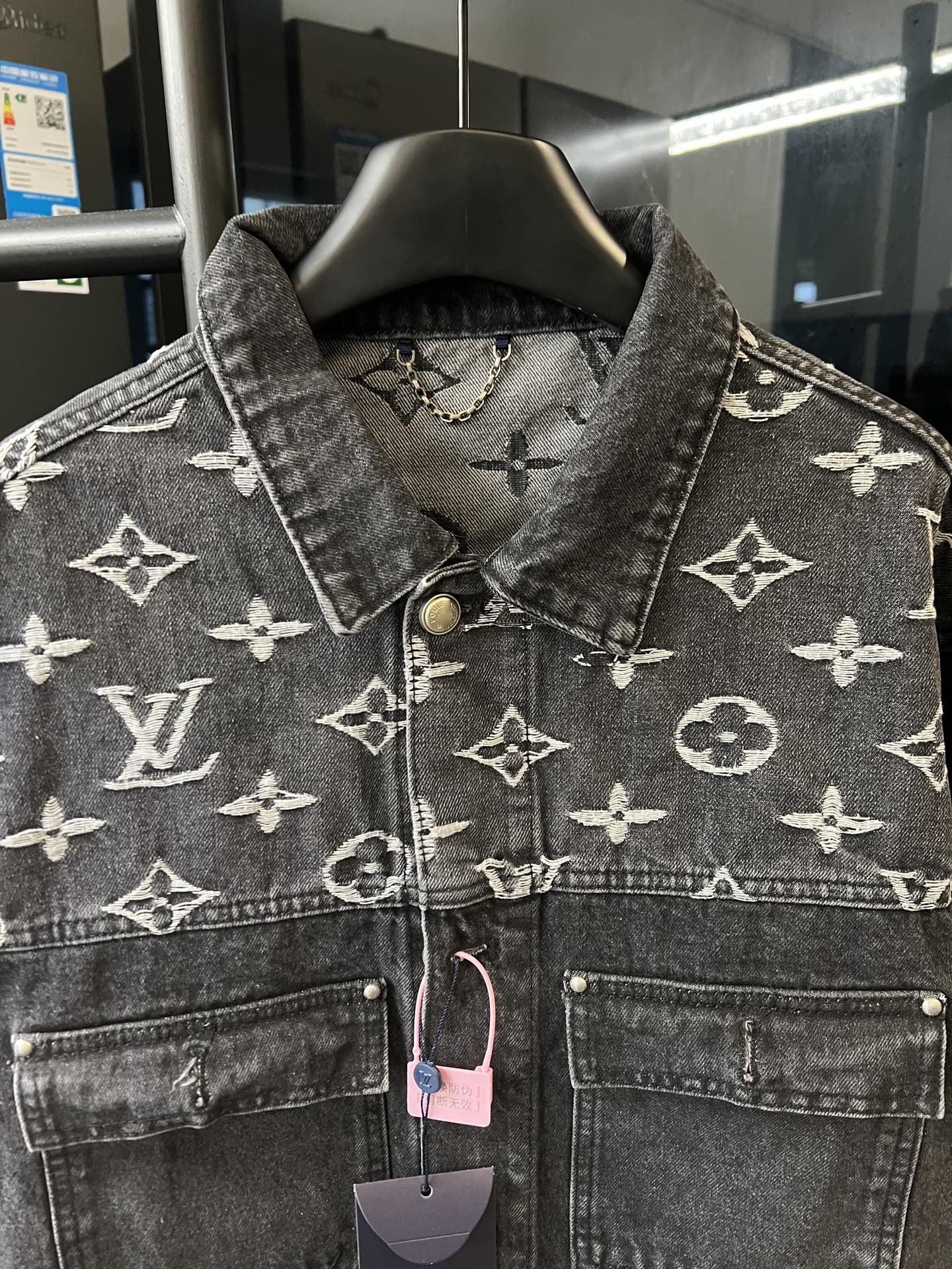 Monogram denim jacket front yoke, button placket and chest pockets, dark gray with cream motifs