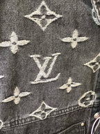 Close-up of denim jacket monogram pattern, dark gray with cream Louis Vuitton icons