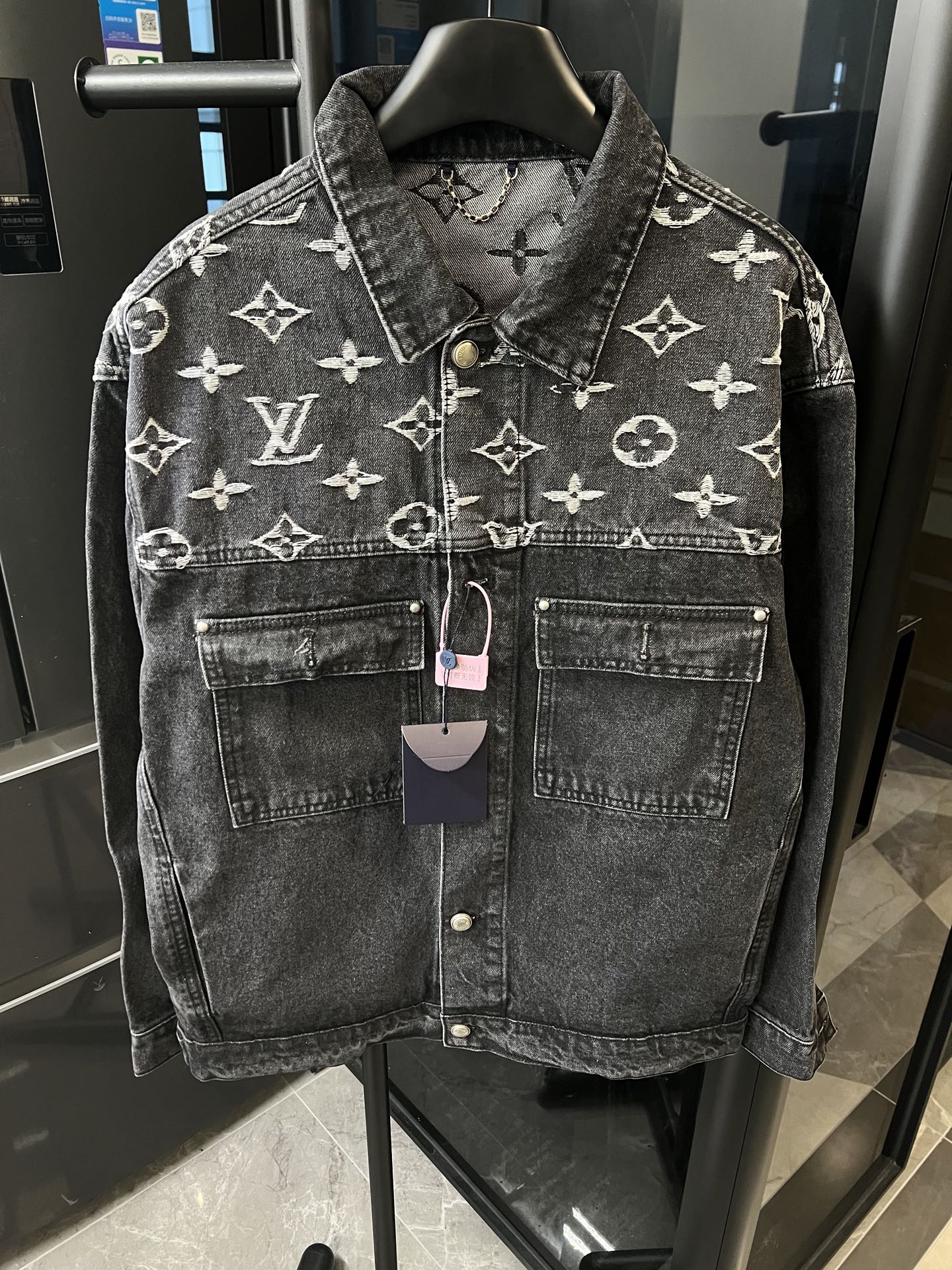 Monogram denim jacket with button front and chest pockets, dark gray; hanging price tags included