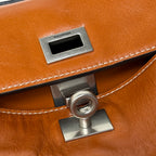 Balenciaga leather handbag front clasp detail with BALENCIAGA logo plate