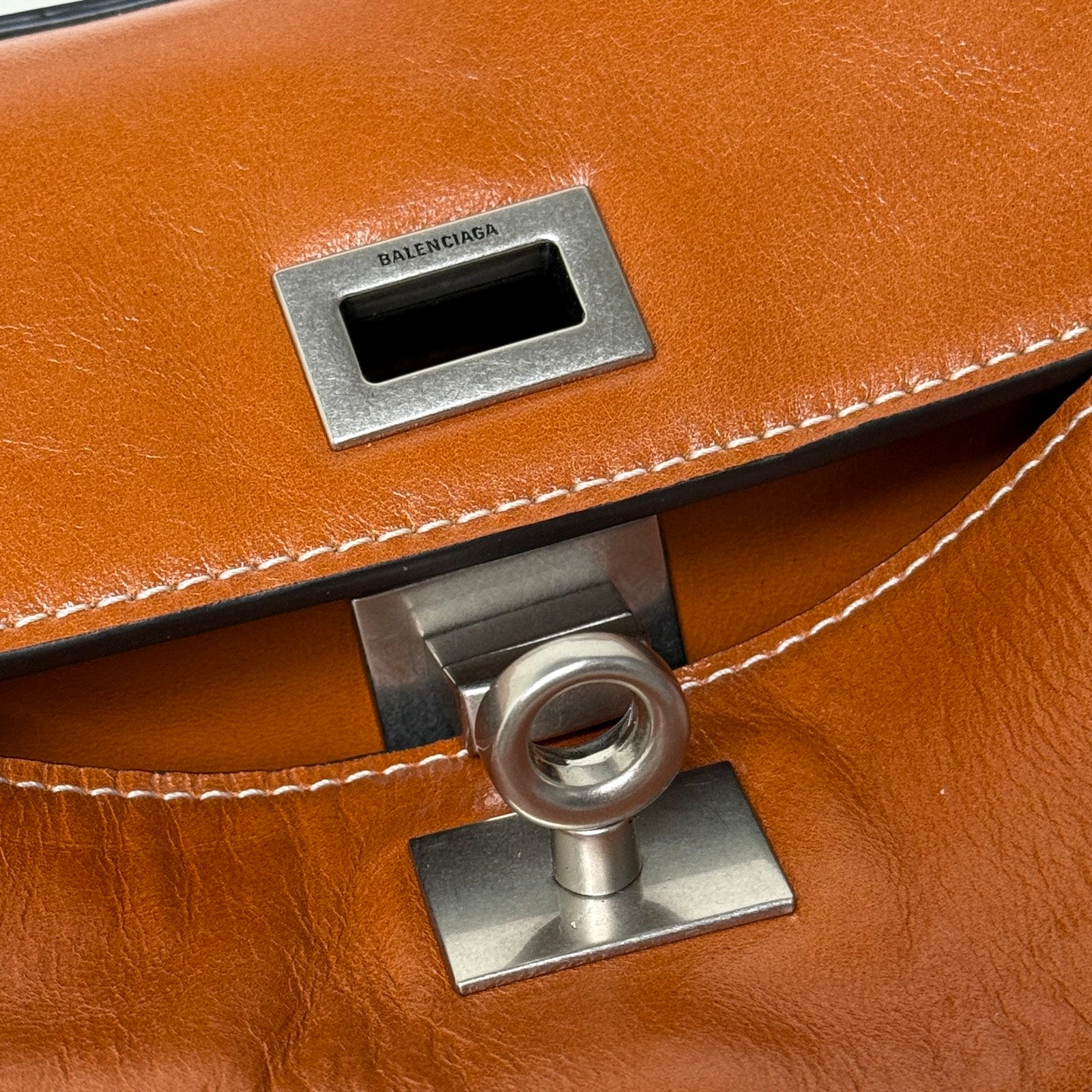 Balenciaga leather handbag front clasp detail with BALENCIAGA logo plate