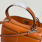 Balenciaga tan leather handbag detail with metallic D-ring strap hardware and lining
