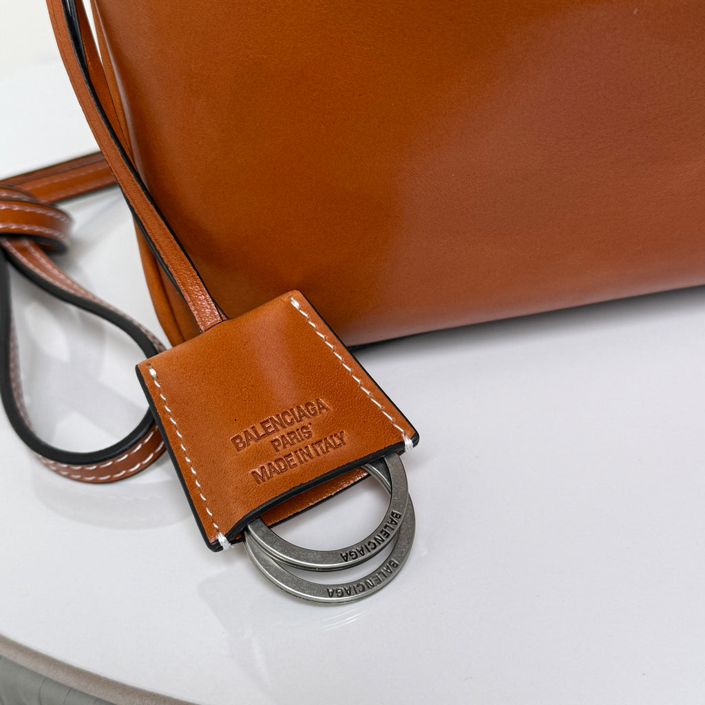 Balenciaga leather bag with brown key fob tag and silver ring charm