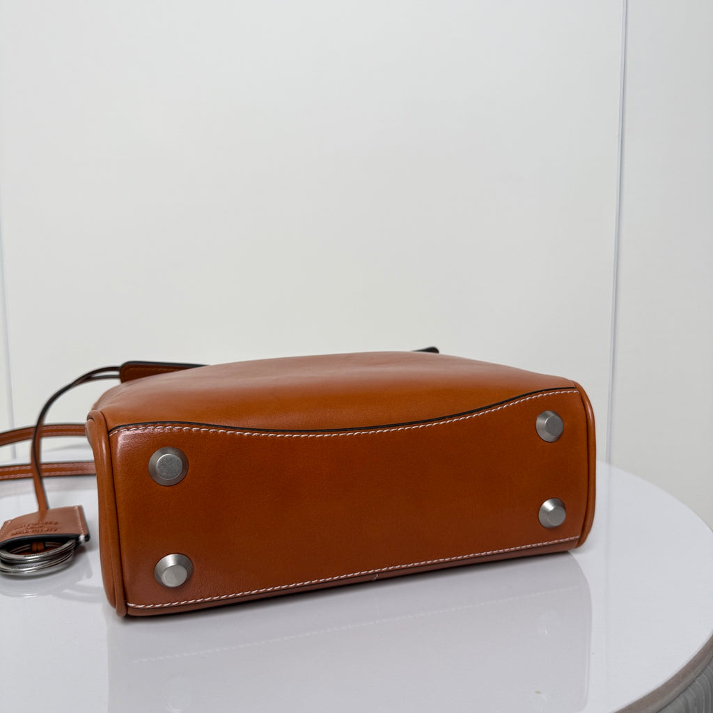 Balenciaga brown leather handbag bottom corner view with metal feet