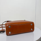 Balenciaga brown leather handbag bottom corner view with metal feet