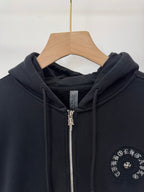 Black zip-up hoodie neckline and hood with drawstrings, zipper, and chest circular emblem.