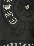 Black hoodie fabric with ornate emblem embroidery