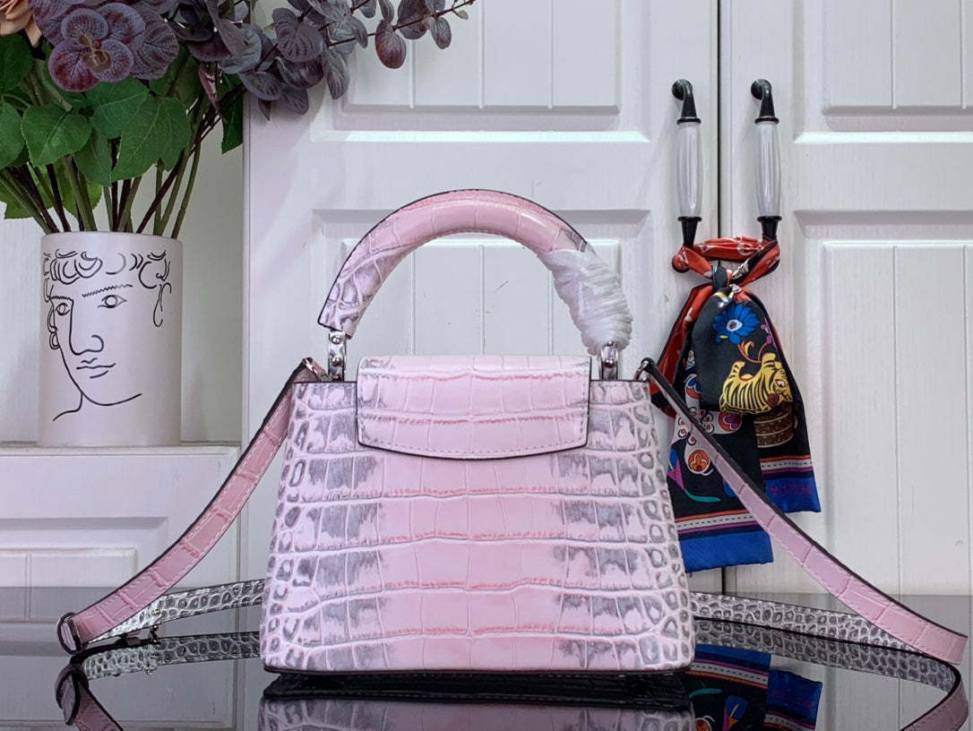 Louis Vuitton pink croc-embossed handbag with front LV emblem and shoulder strap