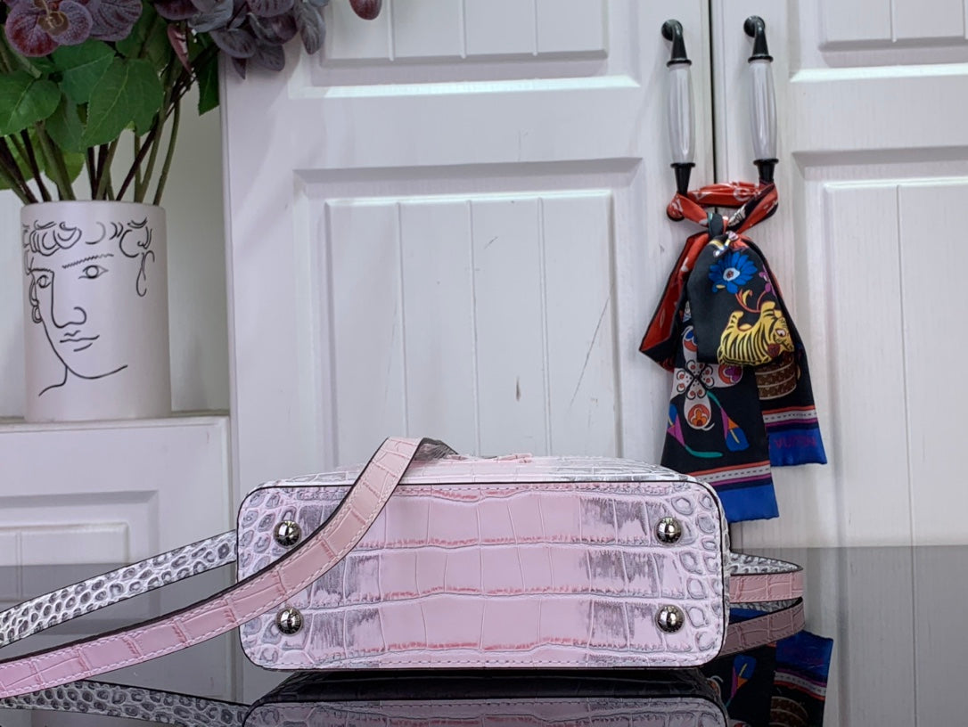 Louis Vuitton pink croc-embossed handbag with snap closure and top handles