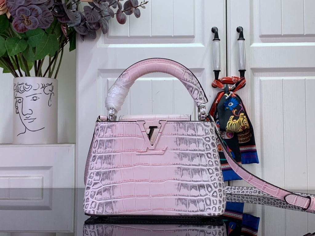 Louis Vuitton pink croc-embossed handbag with top handles and long shoulder strap