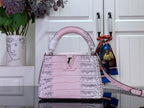 Louis Vuitton pink croc-embossed handbag with top handles and long shoulder strap