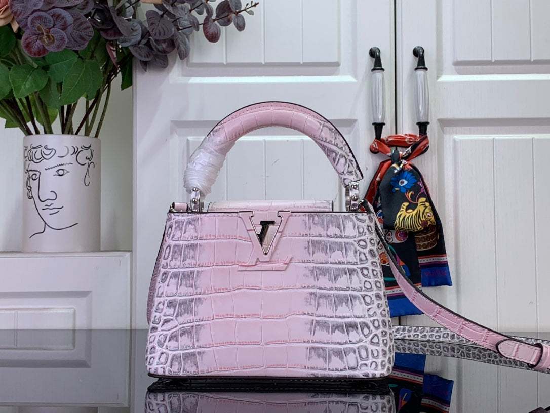 Louis Vuitton pink croc-embossed handbag with top handles and long shoulder strap