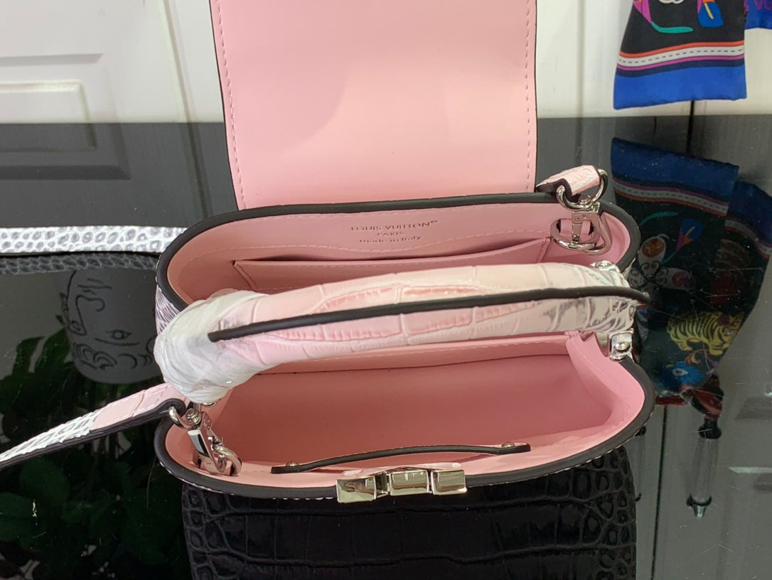 Louis Vuitton pink handbag with open top showing pink interior lining