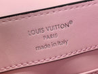 Louis Vuitton pink leather label area with embossed logo text and stitching